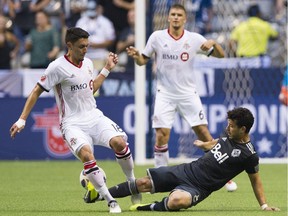 Vancouver Whitecaps' Felipe earns a red card as he tackles Toronto FC's Marco Delgado in leg one of the Canadian Soccer Championship on Wednesday at B.C. Place.