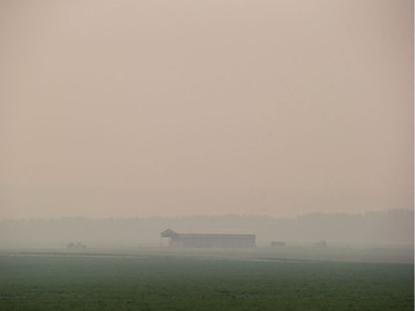 A farm is shrouded in smoke from wildfires burning near Vanderhoof, B.C., on Wednesday August 15, 2018. The British Columbia government has declared a provincial state of emergency to support the response to the more than 500 wildfires burning across the province.
