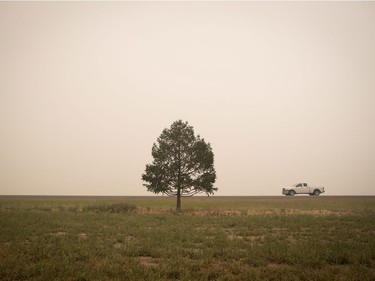 Thick smoke from wildfires fills the air as a motorist travels on Hwy. 27 between Vanderhoof and Fort St. James, B.C., on Wednesday, August 15, 2018. The British Columbia government has declared a provincial state of emergency to support the response to the more than 500 wildfires burning across the province.