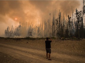 The city of Kimberley has been placed on evacuation alert as wildfires fed by strong, unpredictable winds become more intense in several areas of the province. Verne Tom photographs a wildfire burning approximately 20km southwest of Fort St. James, B.C., on Wednesday, August 15, 2018.