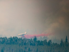 A tanker drops retardant while battling the Shovel Lake wildfire near Fraser Lake, B.C., on Friday August 17, 2018.