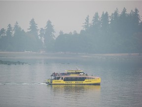 A whale watching boat carrying people leaves the harbour as smoke from wildfires burning in the province fills the air, in Vancouver, on Monday August 20, 2018.