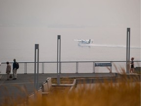 A seaplane takes off from the harbour as smoke from wildfires burning in the province fills the air, in Vancouver, on Monday August 20, 2018.