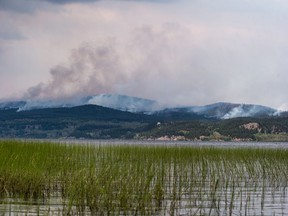 The Shovel Lake wildfire burns on a mountain above Fraser Lake near Fort Fraser on Thursday August 23, 2018.