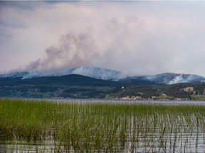 The Shovel Lake wildfire burns on a mountain above Fraser Lake near Fort Fraser, B.C., on Thursday August 23, 2018. The BC Wildfire Service says rainfall and cooler temperatures mean a return to more seasonal weather conditions, reducing the risk of wildfires in the province's northeast.