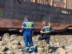 Booms have been placed around a grounded fishing lodge barge so contaminants that may be seeping from its hull don't foul beaches on the east coast of Haida Gwaii.