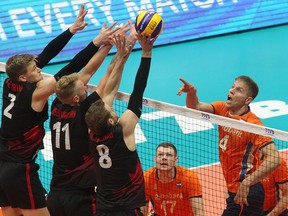 Canada blocks an attack by the Netherlands in winning its first match at the world volleyball championship in Bulgaria, Sept. 12, 2018.