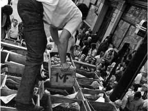 Eager buyers swarm around a truck loaded with apricots and cherries in Vancouver's Gastown in July 1973.  The growers, members of two breakaway groups, were selling the fruits themselves as part of their fight against the B.C. Fruit Growers Association, the only agency allowed to sell fruit in the province at the time.