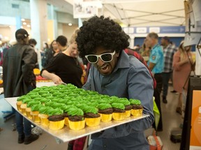 Yats Palat hands out cupcakes at Capilano University in North Vancouver on Monday during a celebration to mark the school's 50th year. College instructors Kevin James and Caroline Dickson have suggestions to help post-secondary students thrive at school.