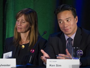 Independent Vancouver mayoral candidate Shauna Sylvester listens as Non-Partisan Association mayoral candidate Ken Sim answers a question on rent control as candidates for Vancouver council participate in a panel discussion on housing hosted by the UBC Sauder Centre for Urban Economics.
