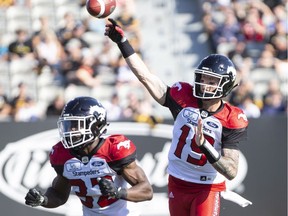 Calgary Stampeders quarterback Bo Levi Mitchell (19) throws during first half CFL Football game action against the Hamilton Tiger-Cats in Hamilton, Ontario on Saturday, September 15, 2018.