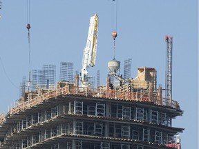 Concrete is poured during construction of a high-rise condo tower at the north end of the Cambie Street Bridge.