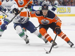 The Canucks' Derrick Pouliot chases the Oilers' Jesse Puljujarvi during the second period.