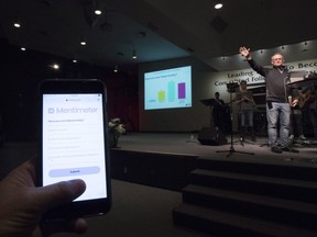 A parishioner uses their smart phone to take part in a church survey put on by Pastor Jeff Germo of the Campbell River Baptist Church, Sunday, Sept, 23, 2018.