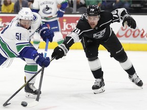 Troy Stecher and Kings forward Tanner Pearson battle for the puck in the first period.