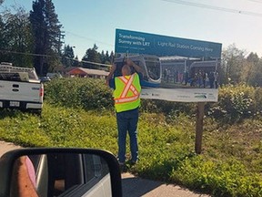 City of Surren worker removes sign marking future site of an LRT station. Elections BC wanted the signs removed because LRT has become an election issue in the city. Handout Sept. 28, 2018 [PNG Merlin Archive]