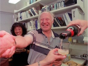 Michael Smith gets congratulations from fellow researchers and assistants in his lab at the University of B.C. with a bottle of champagne after winning Nobel Prize in chemistry in 1993.