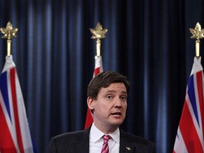 B.C. Attorney-General David Eby answers questions from reporters during a news conference in Victoria. The B.C. government is launching separate reviews into the possibility of money laundering involved in the real estate market, horse racing, luxury vehicle sales and the financial services sector.