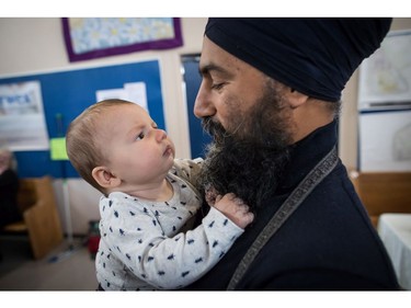 NDP Leader Jagmeet Singh holds Laurier LeSieur, 5 months, while speaking with his parents during a visit to the Rumble on Gray Street Fair, in Burnaby, B.C., on Saturday September 15, 2018. Singh is scheduled to be officially nominated as the party's candidate in the Burnaby-South byelection at a nomination meeting Saturday afternoon.