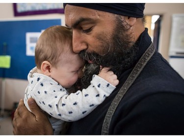 NDP Leader Jagmeet Singh holds Laurier LeSieur, 5 months, while speaking with his parents during a visit to the Rumble on Gray Street Fair, in Burnaby, B.C., on Saturday September 15, 2018. Singh is scheduled to be officially nominated as the party's candidate in the Burnaby-South byelection at a nomination meeting Saturday afternoon.