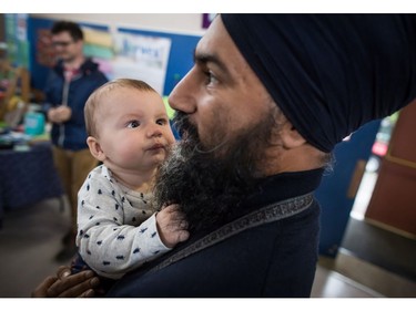 NDP Leader Jagmeet Singh holds Laurier LeSieur, 5 months, while speaking with his parents during a visit to the Rumble on Gray Street Fair, in Burnaby, B.C., on Saturday September 15, 2018. Singh is scheduled to be officially nominated as the party's candidate in the Burnaby-South byelection at a nomination meeting Saturday afternoon.