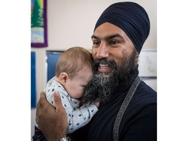 NDP Leader Jagmeet Singh holds Laurier LeSieur, 5 months, while speaking with his parents during a visit to the Rumble on Gray Street Fair, in Burnaby, B.C., on Saturday September 15, 2018. Singh is scheduled to be officially nominated as the party's candidate in the Burnaby-South byelection at a nomination meeting Saturday afternoon.