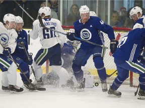 Erik Gudbranson trying to get in control of the puck during a scrimage at Vancouver Canucks 2018 training camp at the Meadow Park Sports Centre in Whistler, BC Saturday, September 15, 2018.