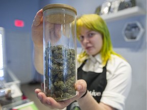 Illegal pot shops are having to adjust their practices with the looming legalization of marijuana in October. Pictured sales associate Tanya Taranenko with a jar of premium marijuana at Eggs Canna Dispensary on Commercial Drive in Vancouver, BC Thursday, September 20, 2018.