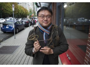 Andy Yan, director of the city program at Simon Fraser University, with a 33-foot surveyors chain from the 1880s.