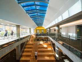 A large wooden staircase connects the two new floors in Vancouver's Central Library.