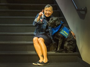 Juliet Walden and Stark pose for a photo at the Michael J. Fox Theatre after the graduation ceremony for the Pacific Assistance Dog Society (PADS) on Sunday.