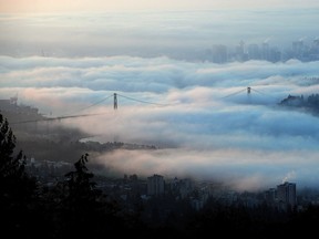 Downtown Vancouver and the Lions Gate Bridge seen through the fog from Cypress Mountain.