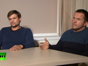 In this video grab provided by RT, Ruslan Boshirov, left, and Alexander Petrov attend their first public appearance in an interview with the Kremlin-funded channel in Moscow, Russia, Thursday, Sept. 13, 2018.