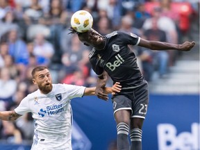 Vancouver Whitecaps' Kei Kamara (23) gets his head on the ball above San Jose Earthquakes' Guram Kashia during the first half of an MLS soccer game in Vancouver, on Saturday September 1, 2018.