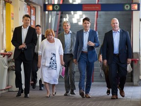 Vancouver Mayor Gregor Robertson, from left to right, Surrey Mayor Linda Hepner, Translink CEO Kevin Desmond, Prime Minister Justin Trudeau and B.C. Premier John Horgan arrive at a Skytrain station in Vancouver, to take a train to a news conference in Surrey, on Tuesday, Sept. 4, 2018.