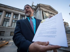 Jay Ritchlin, David Suzuki Foundation Director-General for Western Canada, holds a copy of a lawsuit conservation groups filed in federal court against Fisheries and Oceans Canada regarding the protection of southern resident killer whales, during a news conference in Vancouver, on Wednesday September 5, 2018.