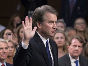 FILE - In this Sept. 4, 2018, file photo, President Donald Trump's Supreme Court nominee Brett Kavanaugh is sworn in before the Senate Judiciary Committee on Capitol Hill in Washington. Both parties are grappling with tremendous political risks in the midst of an increasingly messy Supreme Court fight. Republicans risked alienating women, particularly in the nation's suburbs, by embracing President Trump's hand-picked nominee even after allegations surfaced of decades-old sexual misconduct. Democrats, who want to delay the high-stakes nomination, risked energizing complacent Republican voters should they play politics with the sensitive allegations.