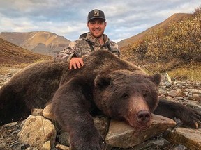 Tim Brent poses with a grizzly bear in this photo from his Twitter page @Brenter37. A former professional hockey player is facing a backlash on social media after he posted photos of a massive grizzly bear he hunted in Yukon. Tim Brent, who was born in Ontario and played for several teams in the NHL, posted the photos on Facebook and Twitter on Sept. 10.
