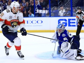 Andrei Vasilevskiy of the Tampa Bay Lightning is forced to make a great save off of Florida Panthers' beast Aleksander Barkov on Oct. 6 in Tampa, Fla.