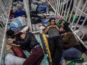 Venezuelan migrants living in Medellin, Colombia, sleep as they wait to attend the second Job Fair for Venezuelans in Colombia, on Sept. 27.