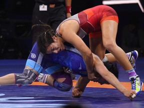 Canada's Justina di Stasio (red) and Mongolia's Nasanburmaa Ochirbat (blue) compete during the final of women's freestyle wrestling -72kg category at the World Wrestling Championships in Budapest, Hungary on October 24, 2018. - Di Stasio won the gold.
