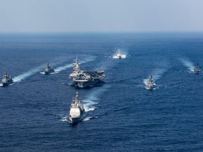 This U.S. navy photo obtained March 31, 2017 shows the Nimitz-class aircraft carrier USS Carl Vinson (CVN 70), Arleigh Burke-class guided-missile destroyer USS Wayne E. Meyer (DDG 108) and Ticonderoga-class guided-missile cruiser USS Lake Champlain (CG 57) as they participate in a photo exercise with Japan Maritime Self-Defence Force destroyers on March 28, 2017 in the Philippine Sea.