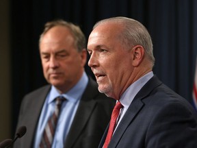 Premier John Horgan and Green Party Leader Andrew Weaver speak to media following the legislation announcement banning union and corporate donations to political parties during a press conference at Legislature in Victoria, B.C., on Monday, September 18, 2017.