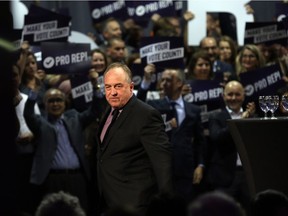 B.C. Green party Leader Andrew Weaver leaves the stage after speaking at a rally Tuesday night in Victoria in support of proportional representation.