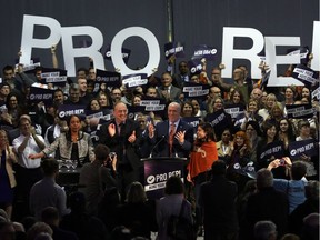 Premier John Horgan, right, and B.C. Green party Leader Andrew Weaver after their speeches at a rally in support of proportional representation at the Victoria Conference Centre on Oct. 23.