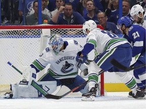 Canucks goaltender Anders Nilsson makes a save against the Lightning's Brayden Point in a 4-1 win on Thursday night.