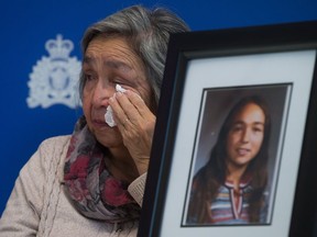 Madeline Lanaro, whose daughter Monica Jack was 12 years old when she was murdered in 1978 near Merritt, B.C., wipes away tears after the RCMP announced an arrest in connection with her murder, on Dec. 1, 2014.