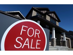 A sign advertises a new home for sale in Carleton Place, Ont., on March 17, 2015. A majority of first-time homebuyers say they maxed out their budgets when they bought their homes, according to a survey released today by the Canada Mortgage and Housing Corp.