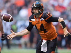 B.C. Lions quarterback Travis Lulay tosses the ball to teammate Emmanuel Arceneaux during first half CFL football action against the Edmonton Eskimos, in Vancouver on Thursday, August 9, 2018.