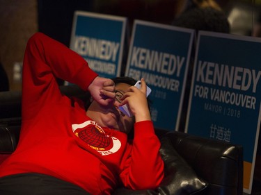 Kennedy Stewart supporter Mike Wu checks his phone after the polls close in Vancouver,  Oct. 20, 2018.